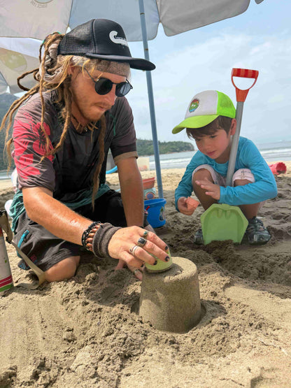 Man and child building sandcastles on a beach